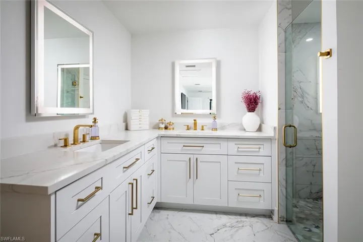 Bathroom with walk in shower and dual vanity