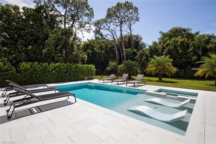 View of pool, spa and a patio area