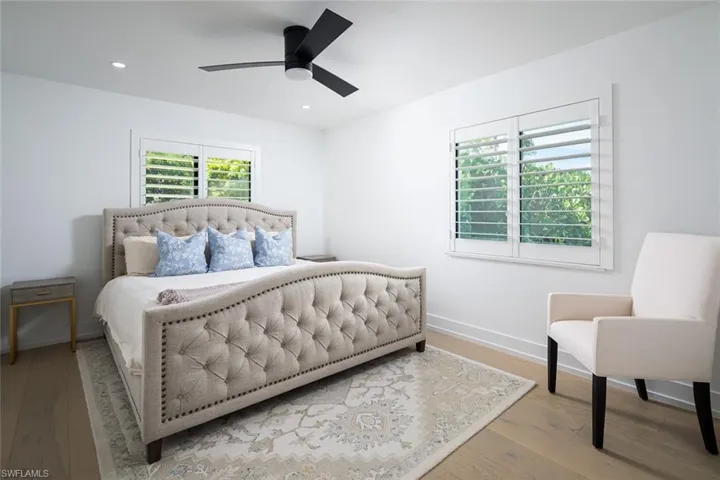 Bedroom with ceiling fan and light hardwood / wood-style floors