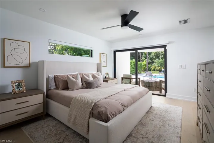 Bedroom featuring ceiling fan, light hardwood / wood-flooring, and access to exterior