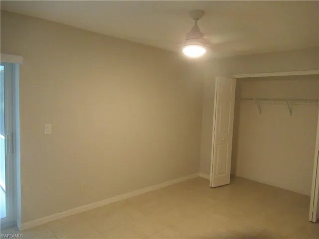 Unfurnished bedroom featuring a ceiling fan and a closet