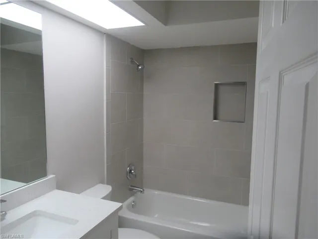 Bathroom with vanity and bathtub / shower combination