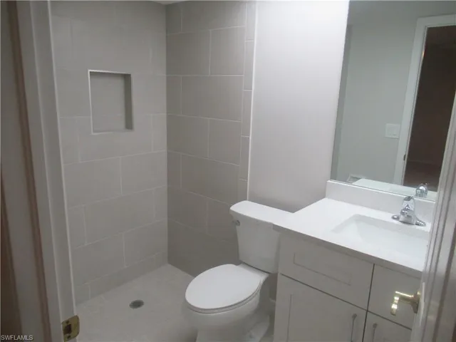 Bathroom featuring vanity and tiled shower