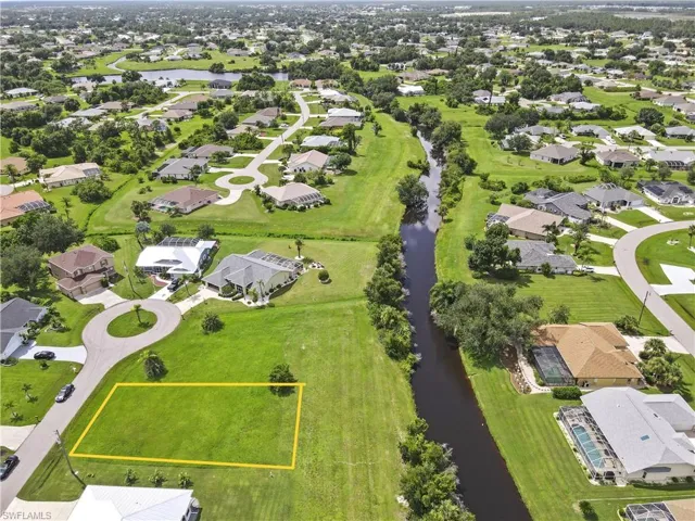 Birds eye view of property with a water view