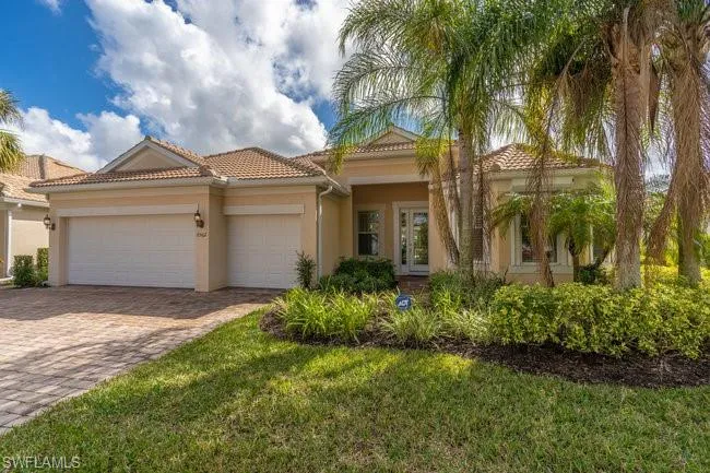 Mediterranean / spanish-style home featuring a garage and a front yard