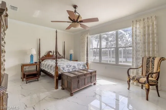 Bedroom with crown molding and ceiling fan