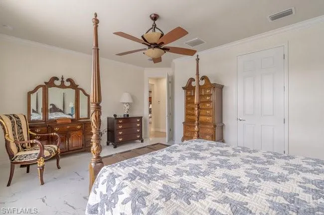 Bedroom featuring ornamental molding and ceiling fan