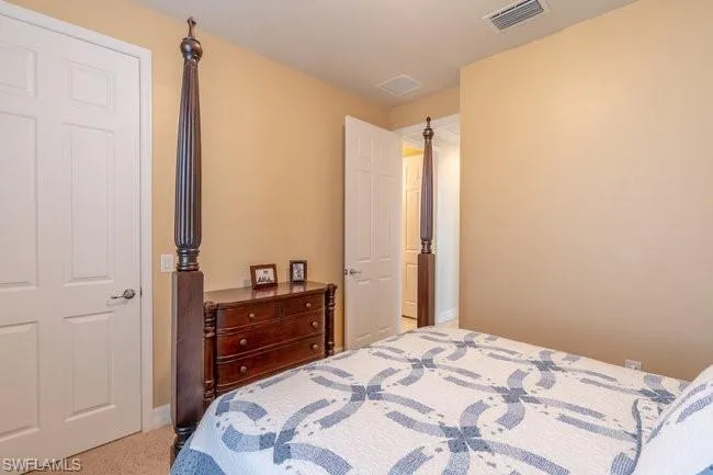 Bedroom featuring light colored carpet