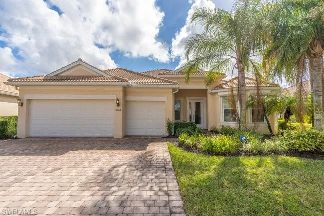 Mediterranean / spanish-style house with a garage and a front yard