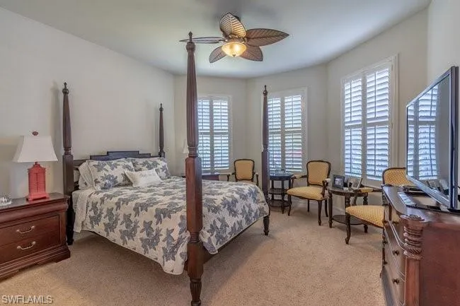 Carpeted bedroom with ceiling fan