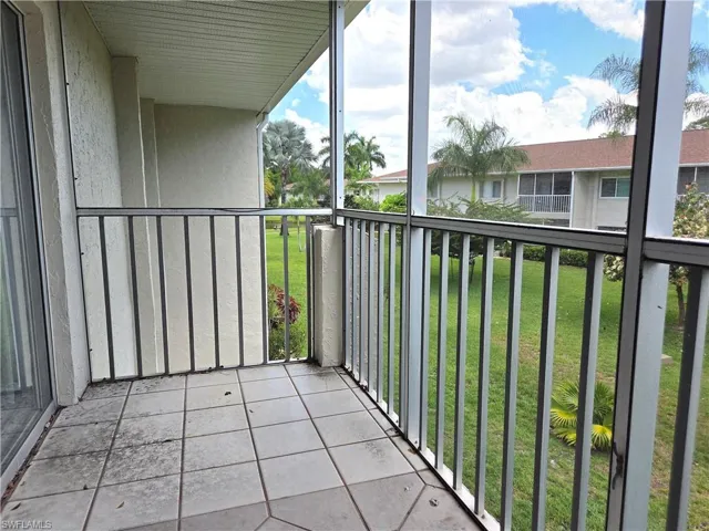 Screened balcony with tiled flooring, featuring a metal railing system