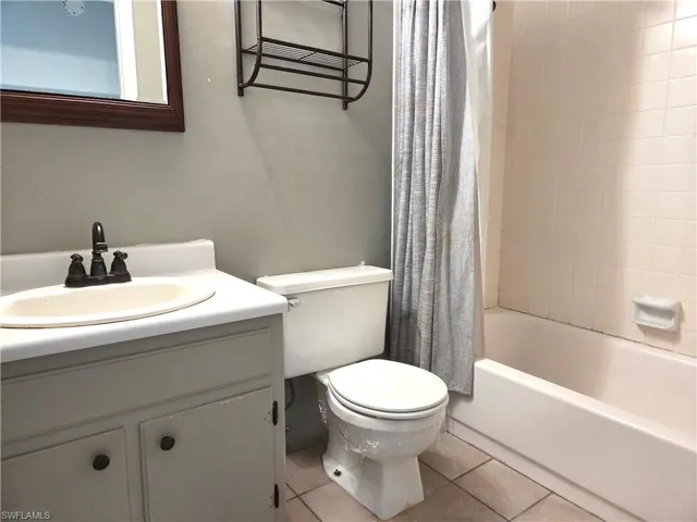 Bathroom with vanity, toilet, and shower-tub combination