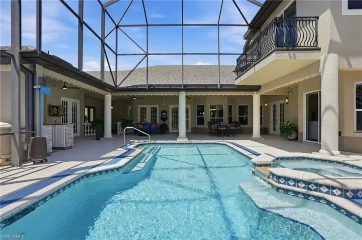 Screen-enclosed outdoor living space, pool and spa