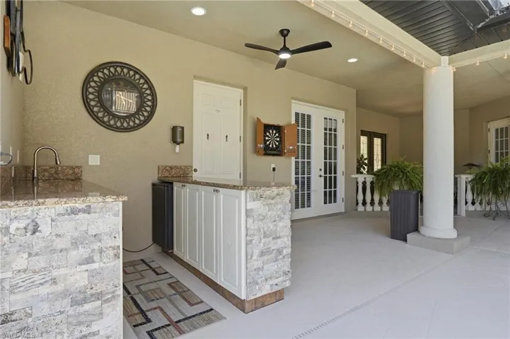 Enclosed lanai featuring an outdoor wet bar