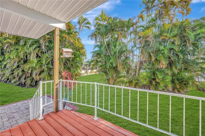 Wooden terrace featuring a lawn