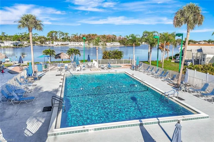 Community pool featuring a patio and a water view