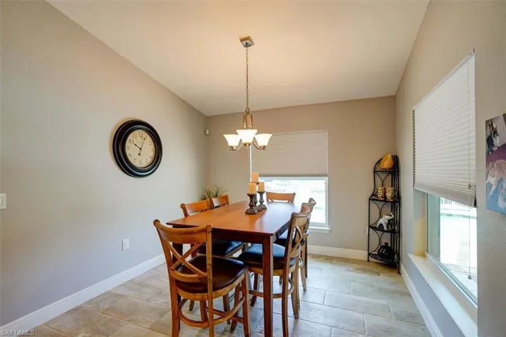 Dining area with vaulted ceiling and a notable chandelier