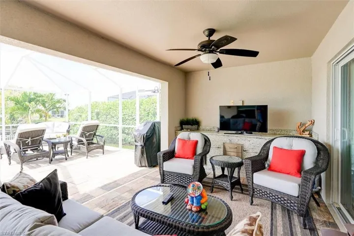 View of patio / terrace with an outdoor bar, ceiling fan, outdoor lounge area, and grilling area