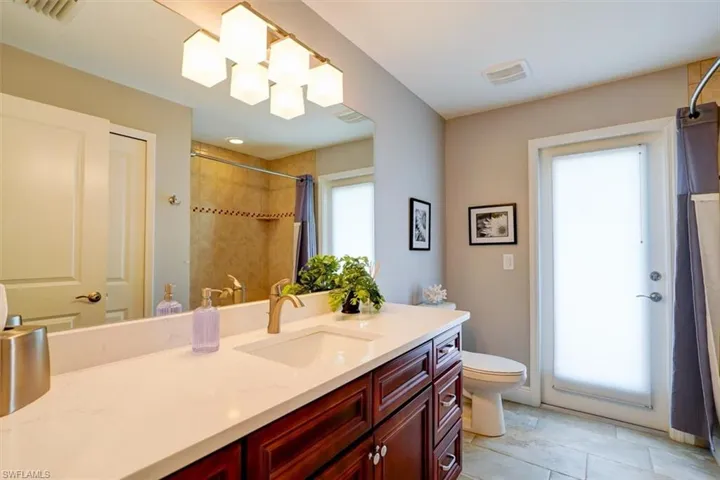 Bathroom featuring vanity, tile patterned floors, and toilet