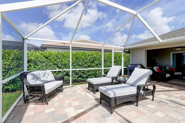 View of patio featuring an outdoor living space, area for grilling, and a lanai