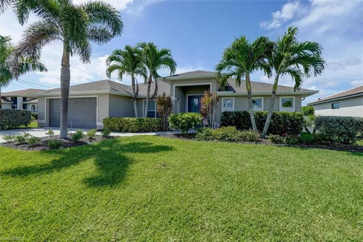 Single story home with a front lawn and a garage