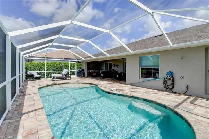 View of pool featuring ceiling fan, a lanai, and a patio area