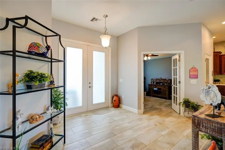 Foyer with ceiling fan and french doors