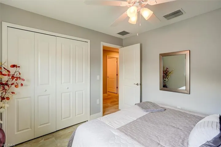 Bedroom featuring ceiling fan and a closet