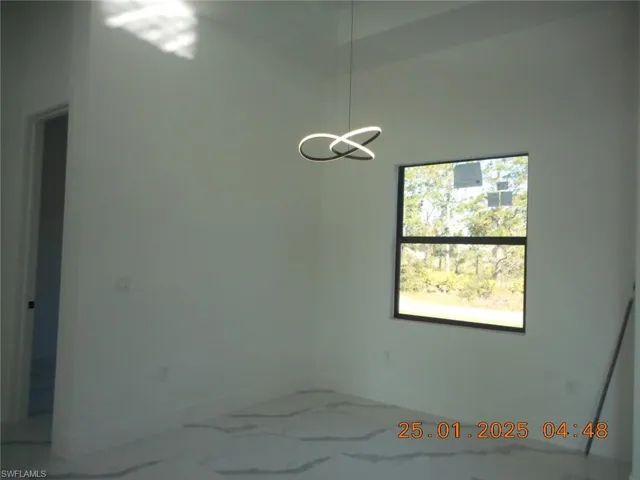 Empty room with a notable chandelier