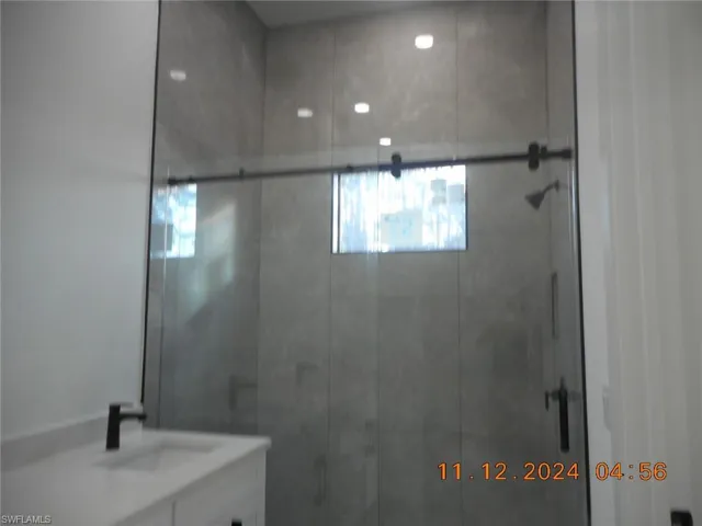 Master Bathroom 1 with vanity and a shower with shower door