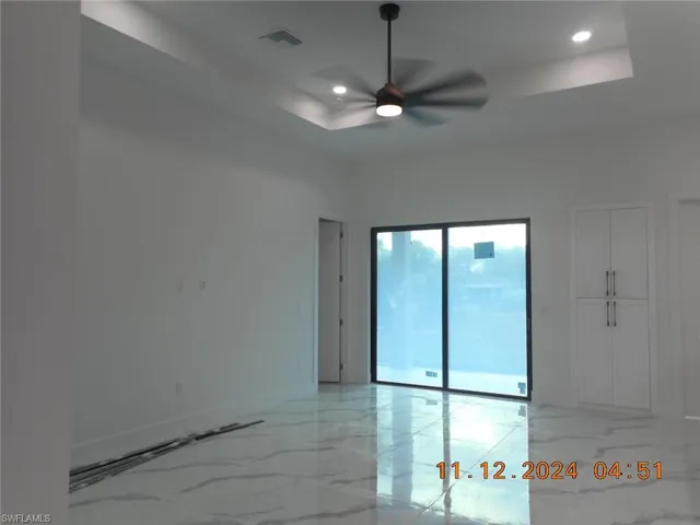 Livin room featuring ceiling fan and a raised ceiling