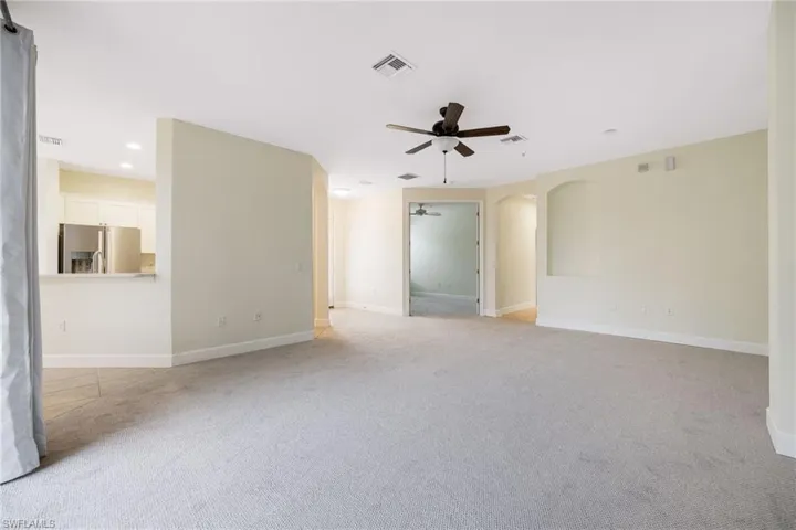 Carpeted spare room with ceiling fan