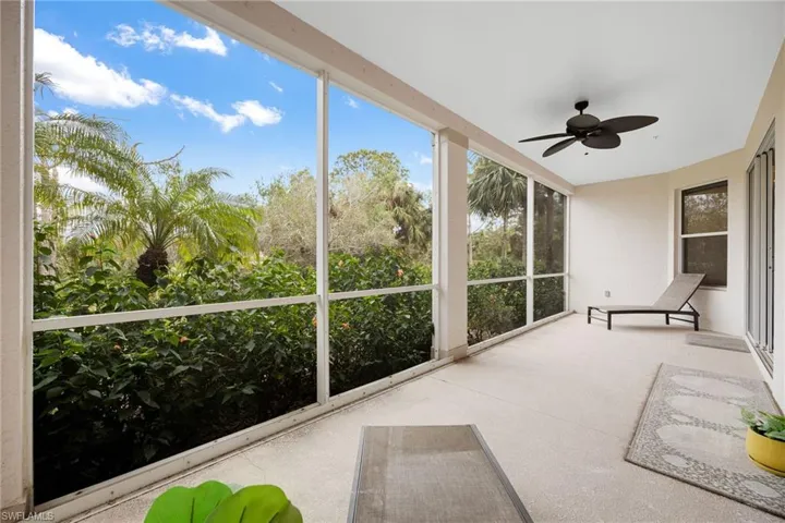 Unfurnished sunroom featuring ceiling fan