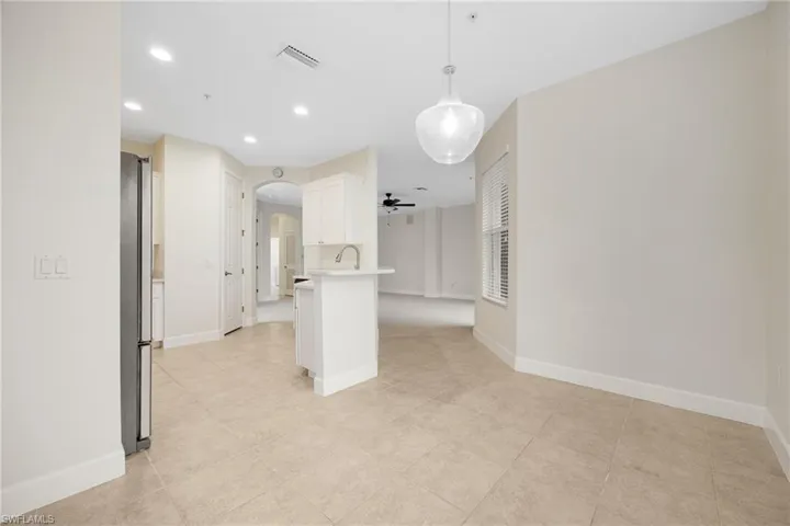 Tiled empty room with sink and ceiling fan