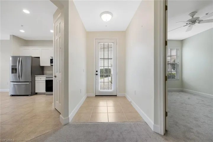 Tiled entrance foyer featuring ceiling fan