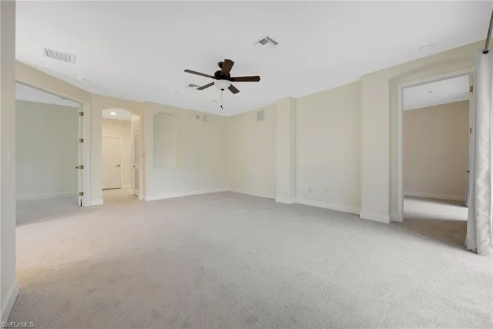 Spare room featuring ceiling fan and light carpet