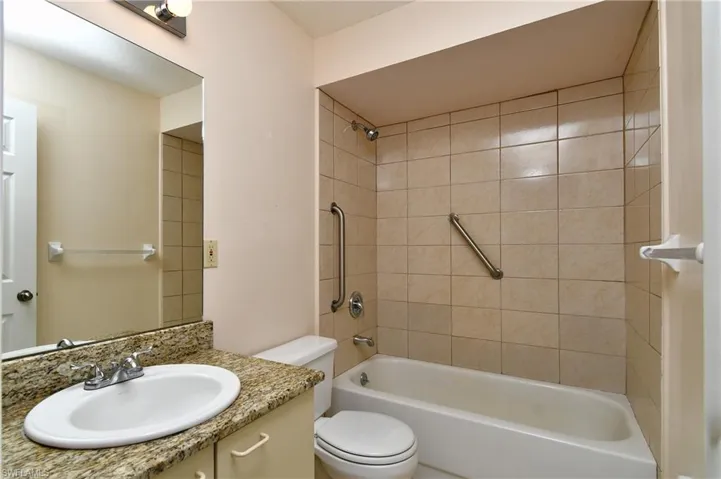 Bathroom with vanity and washtub / shower combination