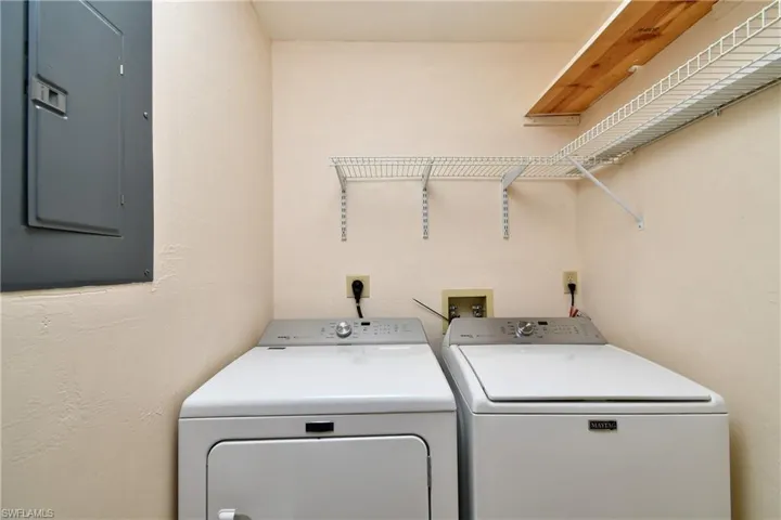 Laundry area featuring separate washer and dryer and electric panel
