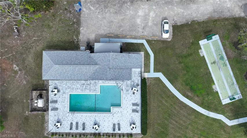 View of subject property with a pool area