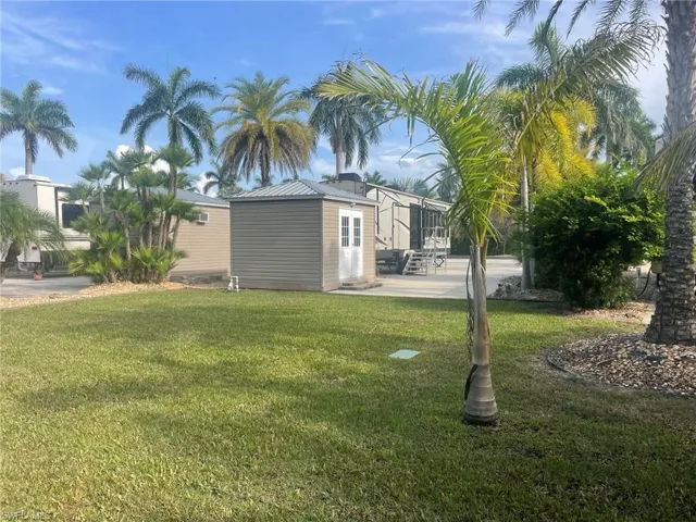 View of green lawn with a patio