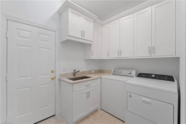 Quartzite leathered countertops with sink and extra Cabico cabinets in your laundry area.