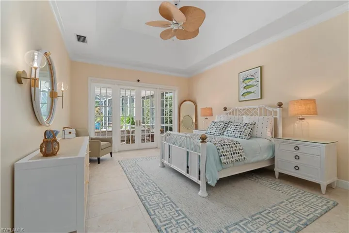Large primary bedroom with access to your Lanai and Casablanca styling ceiling fan.