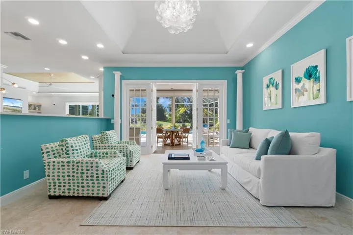 Beautiful chandelier within high tray ceiling.