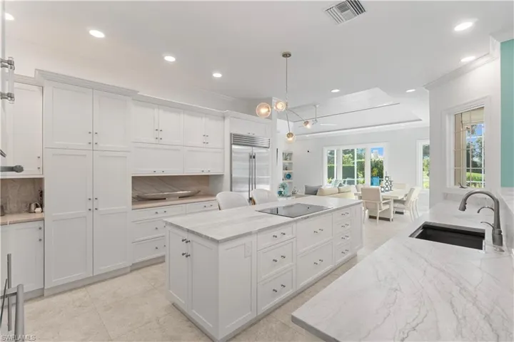 Beautiful kitchen, natural quartzite leathered countertops with Cabico cabinets, two appliance garages, 2 sinks, ice maker, wine cooler, Thermador Cooktop and Oven, Sub zero Refrigerator, and Bosch dishwasher.