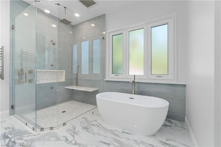 New Cabico cabinets with porcelain tiles throughout, under vanity and shower has dimmable lighting, Kohler rainforest shower with body sprays.