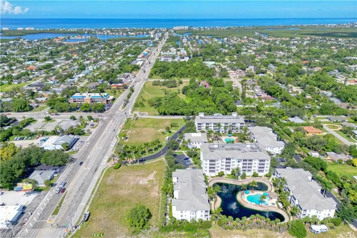 Birds eye view of property with a water view