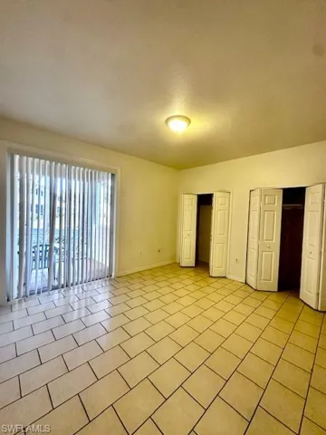 Unfurnished bedroom featuring two closets and a textured ceiling