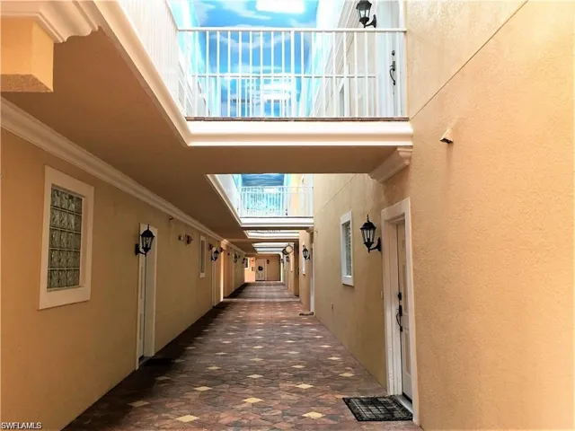 Corridor featuring a high ceiling