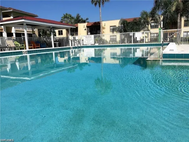 Community pool with a patio