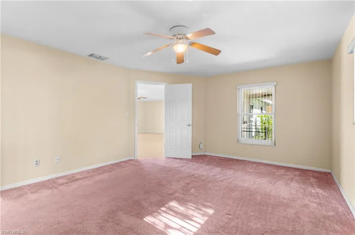 Primary bedroom featuring carpet flooring and a ceiling fan